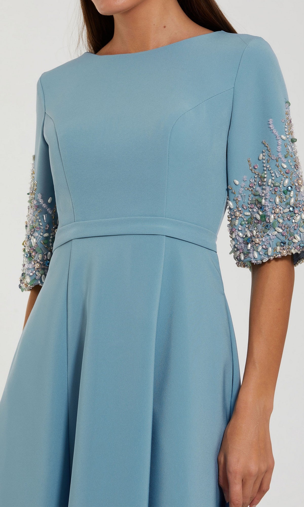 A woman models the Mac Duggal 2322 long formal dress in light blue crepe, featuring elbow-length embellished sleeves; only her upper body is shown.